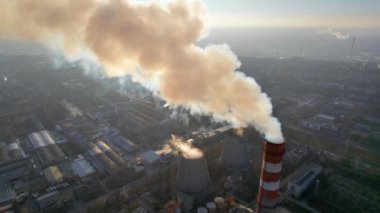 Aerial drone view of thermal power plant in Chisinau, Moldova. View of pipes with felling steam, cityscape