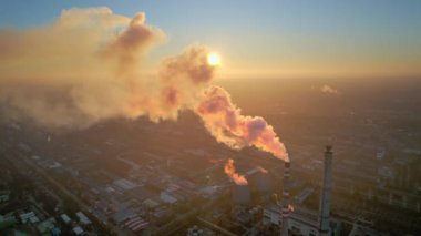 Aerial drone view of thermal power plant in Chisinau at sunset, Moldova. View of pipes with felling steam, cityscape