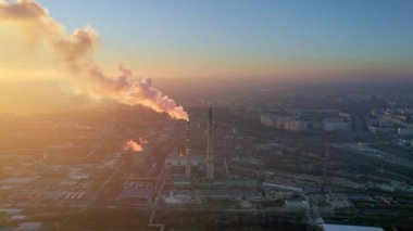 Aerial drone view of thermal power plant in Chisinau at sunset, Moldova. View of pipes with felling steam, cityscape