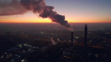 Aerial drone view of thermal power plant in Chisinau at sunset, Moldova. View of pipes with felling steam, cityscape