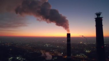 Aerial drone view of thermal power plant in Chisinau at sunset, Moldova. View of pipes with felling steam, cityscape