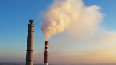 Aerial drone view of thermal power plant in Chisinau, Moldova. View of pipes with felling steam, blue sky