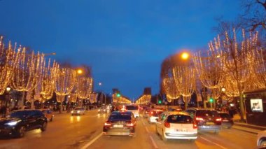 PARIS, FRANCE - DECEMBER, 2022: Timelapse of road at Avenue des Champs-Elysees at night