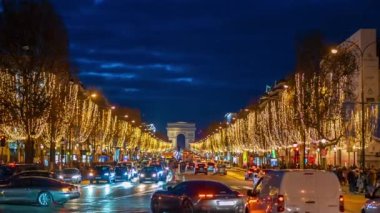 PARIS, FRANCE - DECEMBER, 2022: Timelapse of road at Avenue des Champs-Elysees at night