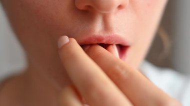 Evde vitamin hapı alan bir kadın var.