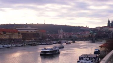 Vltava River and city with buildings, boats on river, Czech Republic