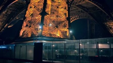 Close view of the illuminated Eiffel Tower in Paris at night, France. Multiple nightlights, bottom view