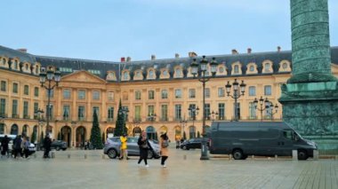 PARIS, FRANCE - JANUARY, 2022: View of The Vendome Place in city downtown. Walking people, Vendome Column and old classic buildings, cloudy sky