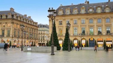 PARIS, FRANCE - JANUARY, 2022: View of The Vendome Place in city downtown. Walking people and old classic buildings, cloudy sky