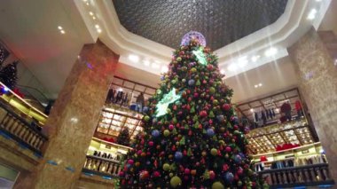 PARIS, FRANCE - DECEMBER, 2022: View of a shopping mall interior with Christmas tree and decorations, people