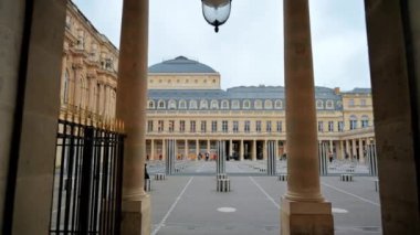PARIS, FRANCE - JANUARY, 2022: View of The Palais-Royal in city downtown. Inner court with tourists, cloudy weather