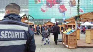 PARIS, FRANCE - DECEMBER, 2022: View of the Christmas fair in business centre, shops and walking people