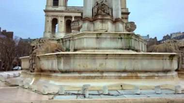 PARIS, FRANCE - DECEMBER, 2022: View of The Church of Saint-Sulpice and square with fountain and people in front of it