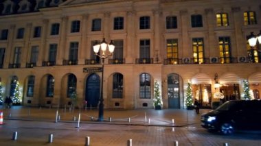PARIS, FRANCE - DECEMBER, 2022: View of The Vendome Place in city downtown at night. Ministry of Justice, classic buildings, Christmas decorations