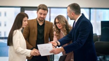 Business meeting in an office, workers discussing business affairs using papers with charts