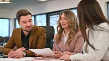 Business meeting in an office, workers discussing business affairs using papers. Slow motion