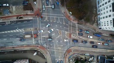 Aerial drone vertical view of a crossroad in Hamburg, Germany. Moving cars, bare trees, buildings