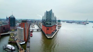 Aerial drone view of Speicherstadt in Hamburg, Germany. Residential district with classic and modern buildings, water channels, Elbe river. Cloudy weather