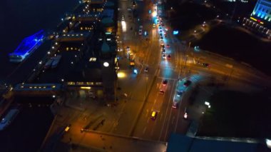 Aerial drone view of Hamburg at evening, Germany. Elbe coastline, moored boats, sea port, classic and modern buildings, roads with cars and nightlights