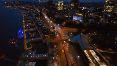 HAMBURG, Almanya - 2023 HAMBURG: Akşam, Almanya Hamburg 'un hava aracı görüntüsü. Elbe kıyı şeridi, demirli tekneler, liman, klasik ve modern binalar, arabalı yollar ve gece lambaları.
