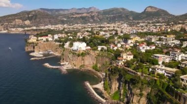 Aerial drone view of Sorrento sea coast with beaches and buildings, Italy