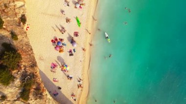 Aerial drone view of Zakynthos nature and sea, Greece, people on the beach with umbrellas