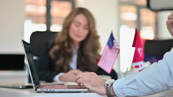 在办公室举行商务会议时 女工一边写作一边用笔记本电脑 小工具和美国国旗在桌子上 慢动作 — 图库视频影像