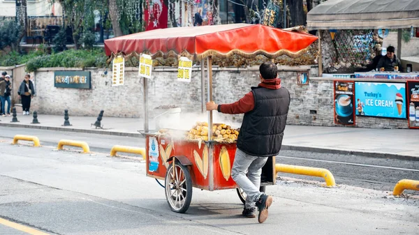 Stock image ISTANBUL, TURKEY - MARCH, 2023: A street vendor rolls a cart with street food