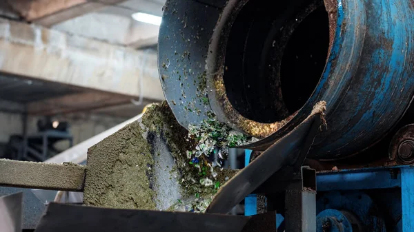 stock image Process of sorting glass garbage on a vibrating conveyor belt at waste sorting plant