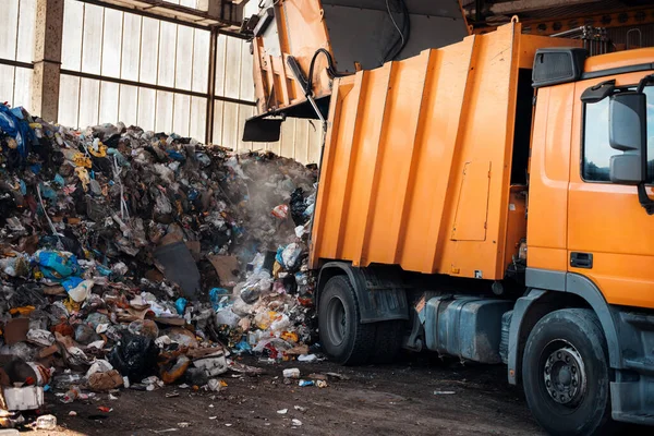 stock image An garbage truck unloading garbage at waste sorting plant