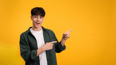 Gülümseyen genç adam sarı arka planda onun yanında görünüyor.