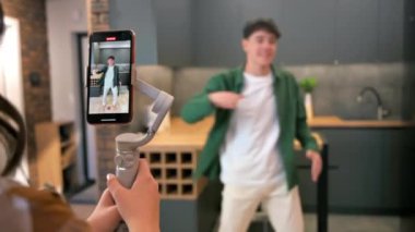 Dans eden genç bir blogcuyu kaydeden kişi akıllı telefondan bir stüdyoda dengeleyiciye nüfuz ediyor.