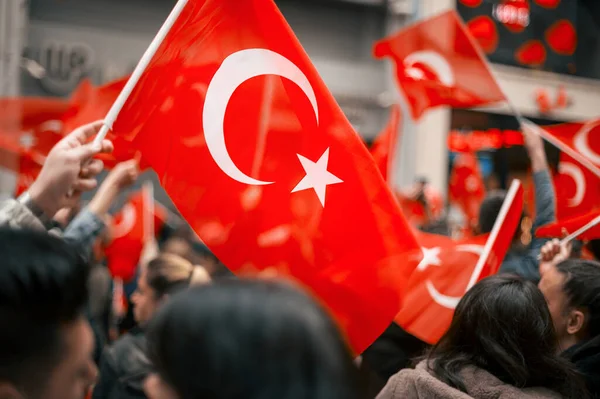 People waving turkish flag in the street at the Commemoration of Ataturk, Youth and Sports Day in Istanbul, Turkey