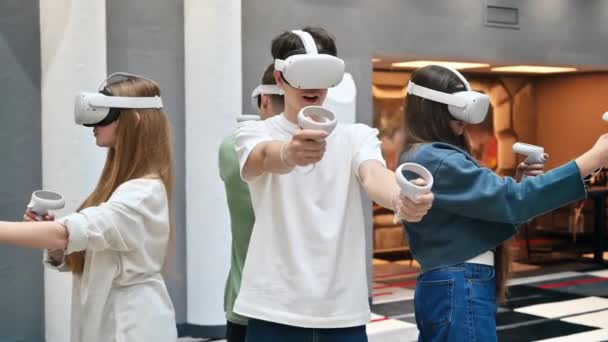Grupo Cuatro Adolescentes Con Auriculares Controladores Jugando Juegos Equipo Una — Vídeo de stock