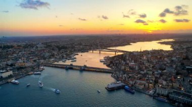 Türkiye 'de gün batımında İstanbul' un hava aracı görüntüsü. Altın Boynuz su yolu üzerinde yüzen gemileri olan çok sayıda bina, cami, Galata ve Metro köprüsü.