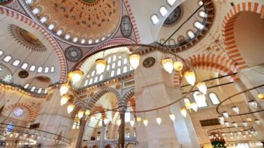 İstanbul, Türkiye 'deki Süleyman Camii' nin iç manzarası. Bir sürü aydınlatma, boyanmış tavan.