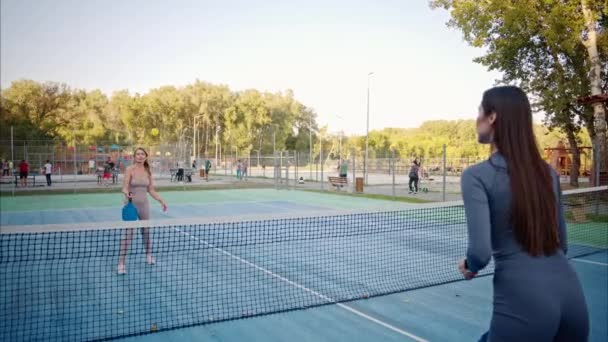 Women Playing Pickleball Yellow Ball Blue Paddle Court — Stock Video