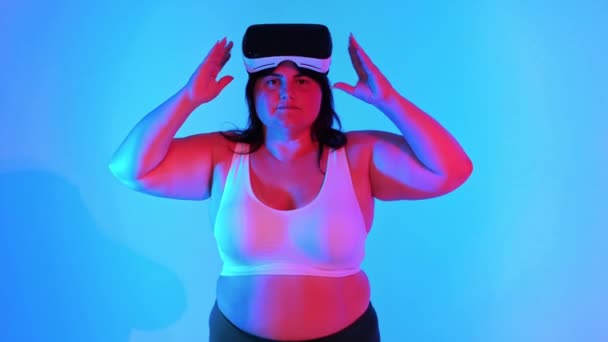 Woman Overweight Tracksuit Headset Posing Studio Blue Background Red Illumination — Stock Video