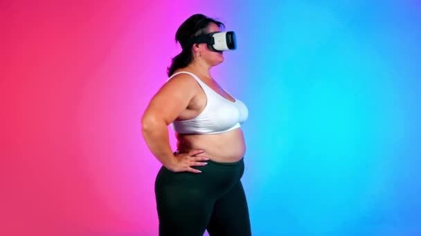 Woman Overweight Tracksuit Headset Doing Exercises Studio Blue Red Background — Stock Video