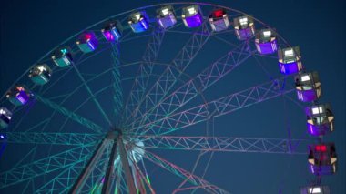 Cannes, Fransa 'da gece boyunca canlı, renkli ışık saçan dönme dolap.