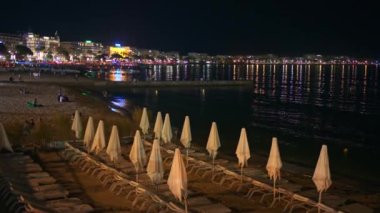 Geceleri Croisette Bulvarı yakınlarında Majestic plajı. Sahilde oynayan insanlar