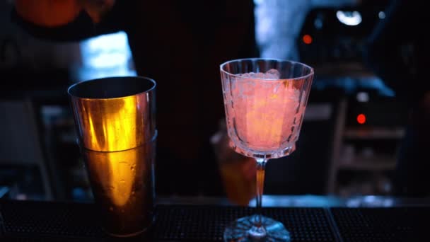 Barman Pouring Orange Red Alcohol Cocktail Ice Bar Neon Lights — Stock Video