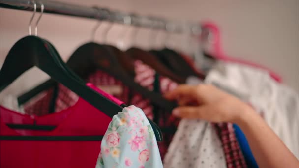 stock video Close-up of Female Hands Plucked Hanger choosing clothes in wardrobe