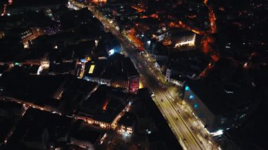 Bükreş, Romanya - 03 Mart 2024: Geceleri aydınlanan şehir manzarasının insansız hava aracı görüntüsü. Trafiği yolda hareket ettiriyor