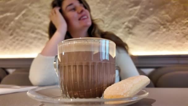 布鲁内特 一个年轻女人在咖啡店喝咖啡和饼干 — 图库视频影像
