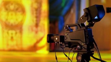 Profesyonel kamera bir televizyon setinin sahne arkasında çekim yapıyor.