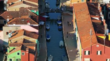 İtalya, Burano 'daki renkli evlerin yakınındaki bir kanalın kenarındaki teknelerin hava manzarası.