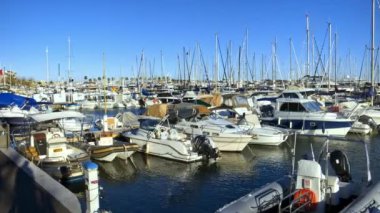 Güzel, Fransa - 12 Mayıs 2024: Birçok beyaz tekne arka planda mavi gökyüzü olan bir limana yanaştı