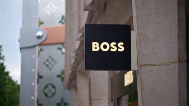 Paris, Fransa - 18 Haziran 2024: Arkasında Louis Vuitton mağazası olan Hugo Boss mağazasının imzası
