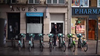 Paris, Fransa - 18 Haziran 2024: Yeşil ve turkuaz elektrikli bisikletler sokağa park edildi